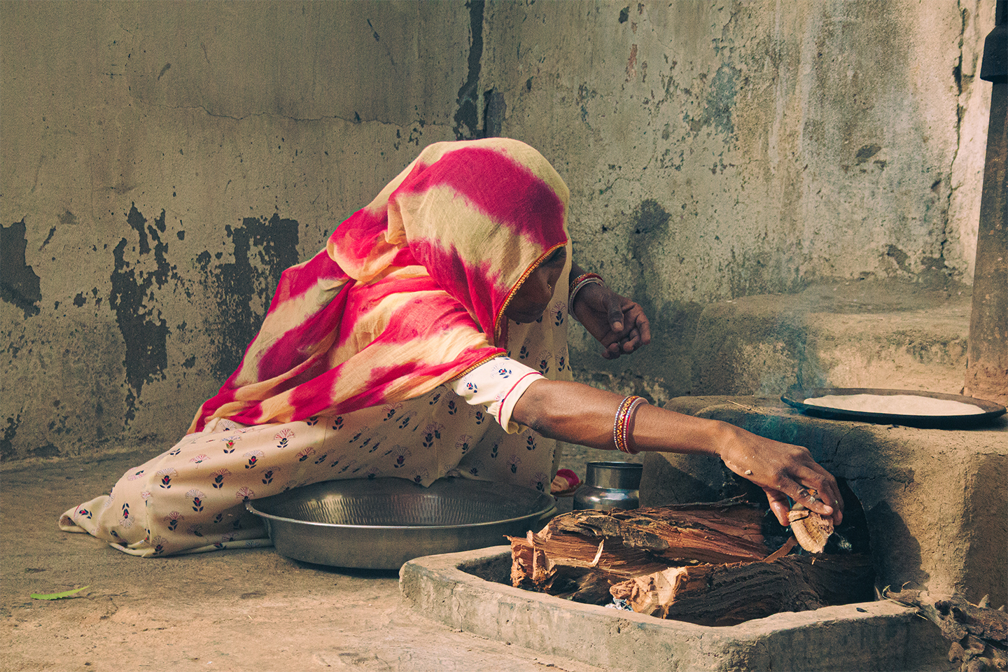 A woman preparing a traditional roti