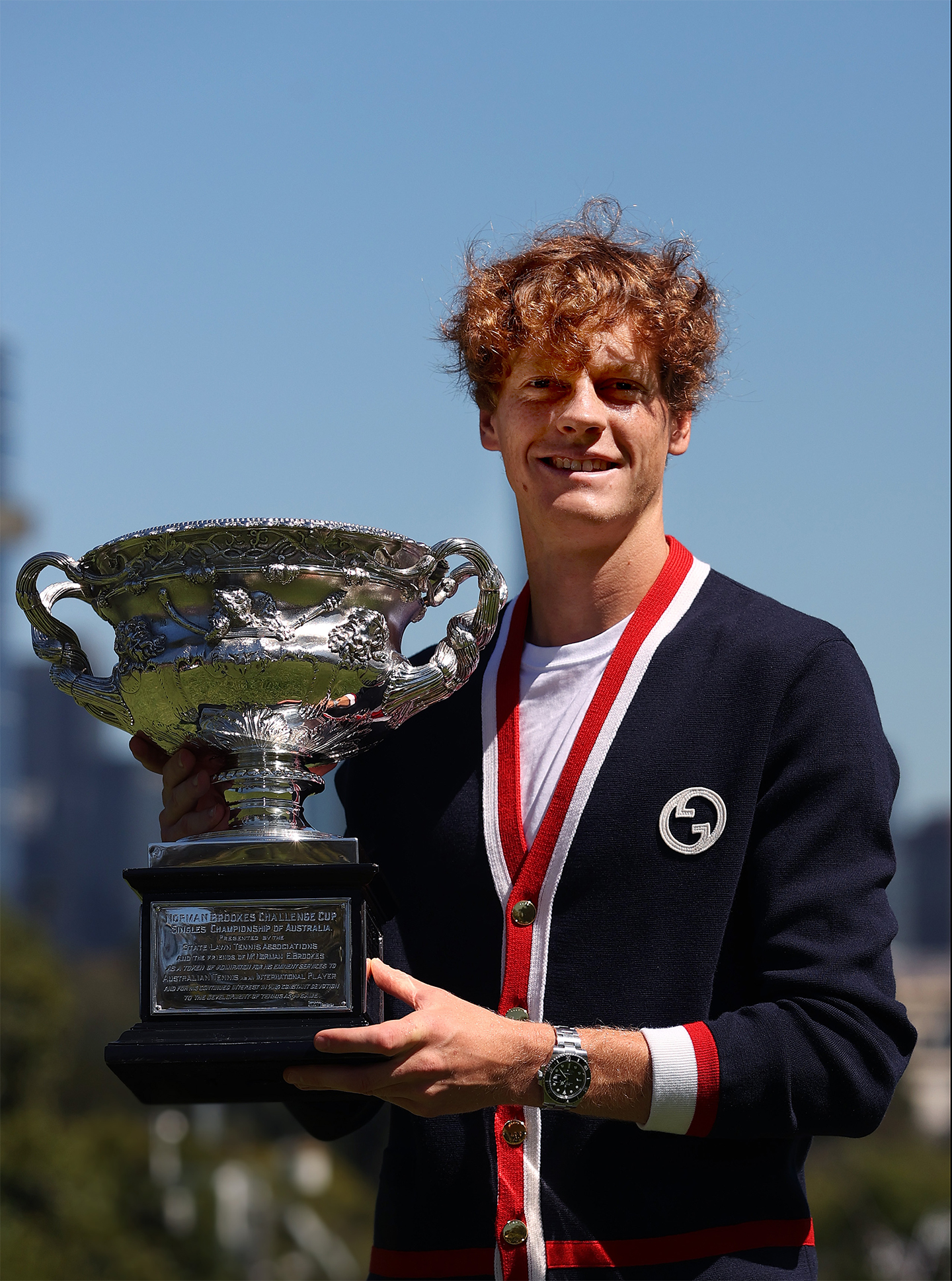Jannik Sinner sported a Gucci cardigan while posing with the Norman Brookes Challenge Cup after winning the 2024 Australian Open Final at the Royal Botanic Gardens in Melbourne, Australia. Courtesy of Gucci. Image courtesy of Getty Images