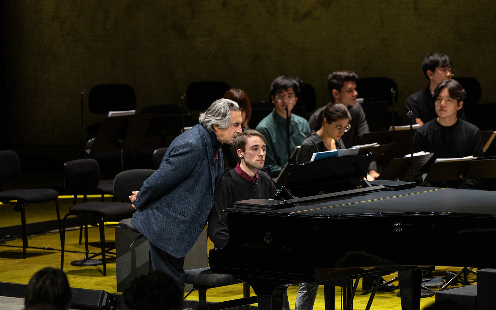 At the piano, Muti mentors young talent, showing how mastery, listening, and discipline underpin every creative practice.