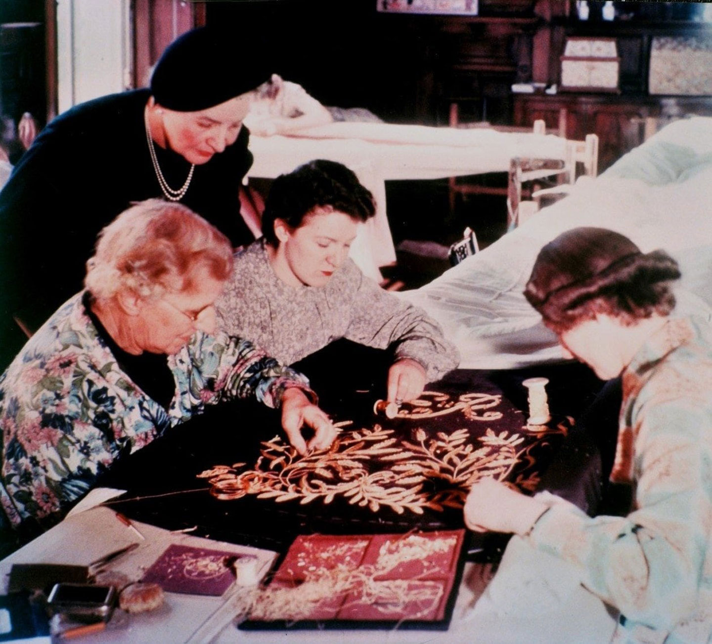 Members of the Royal School of Needlework work with gold embroidery on the Purple Robe of Estate, part of the set of robes for the forthcoming Coronation of Queen Elizabeth II, in London circa 1953