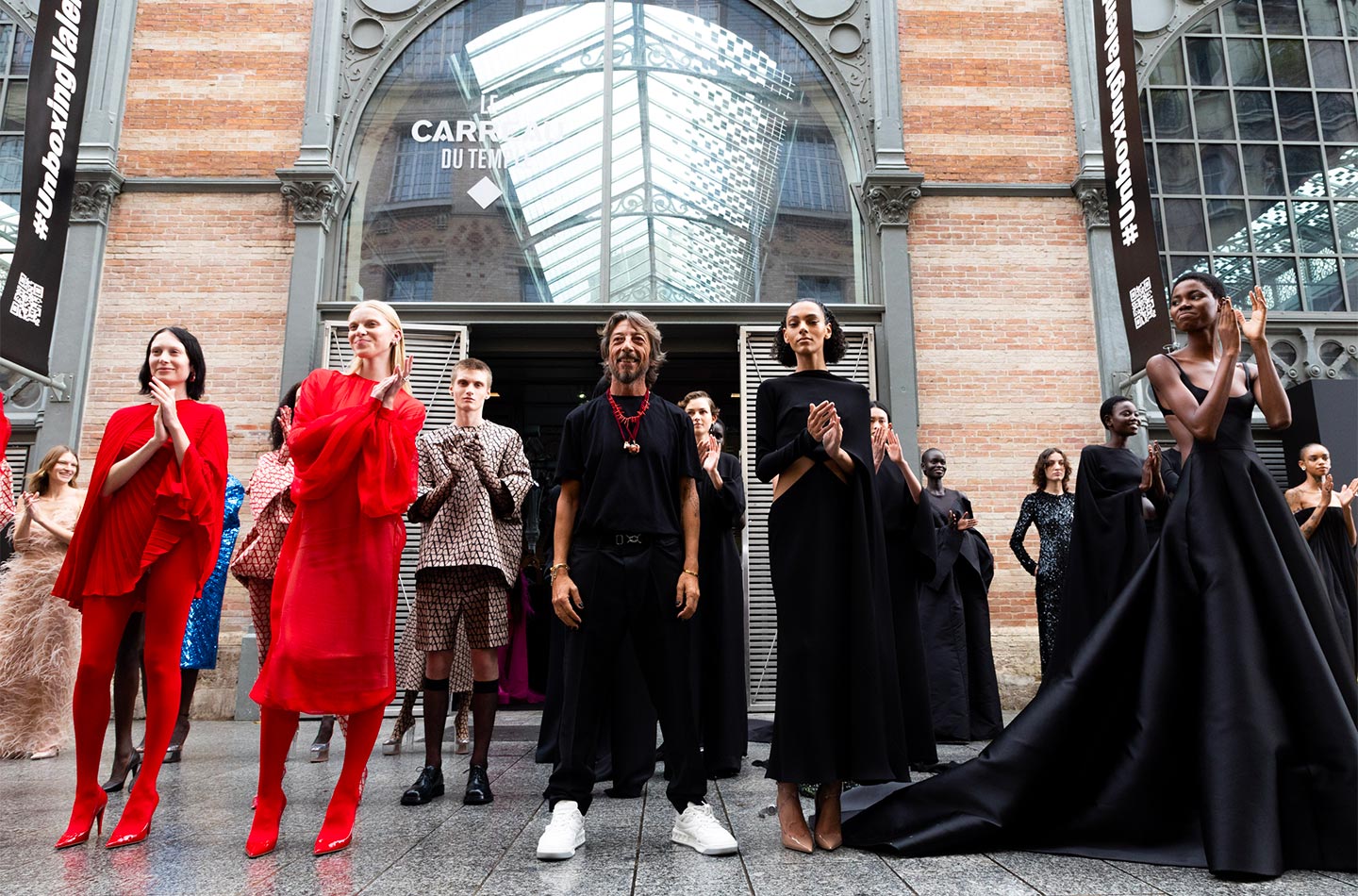 Models with creative director Pierpaolo Piccioli at the end of the Valentino Unboxing s-s 23 fashion show