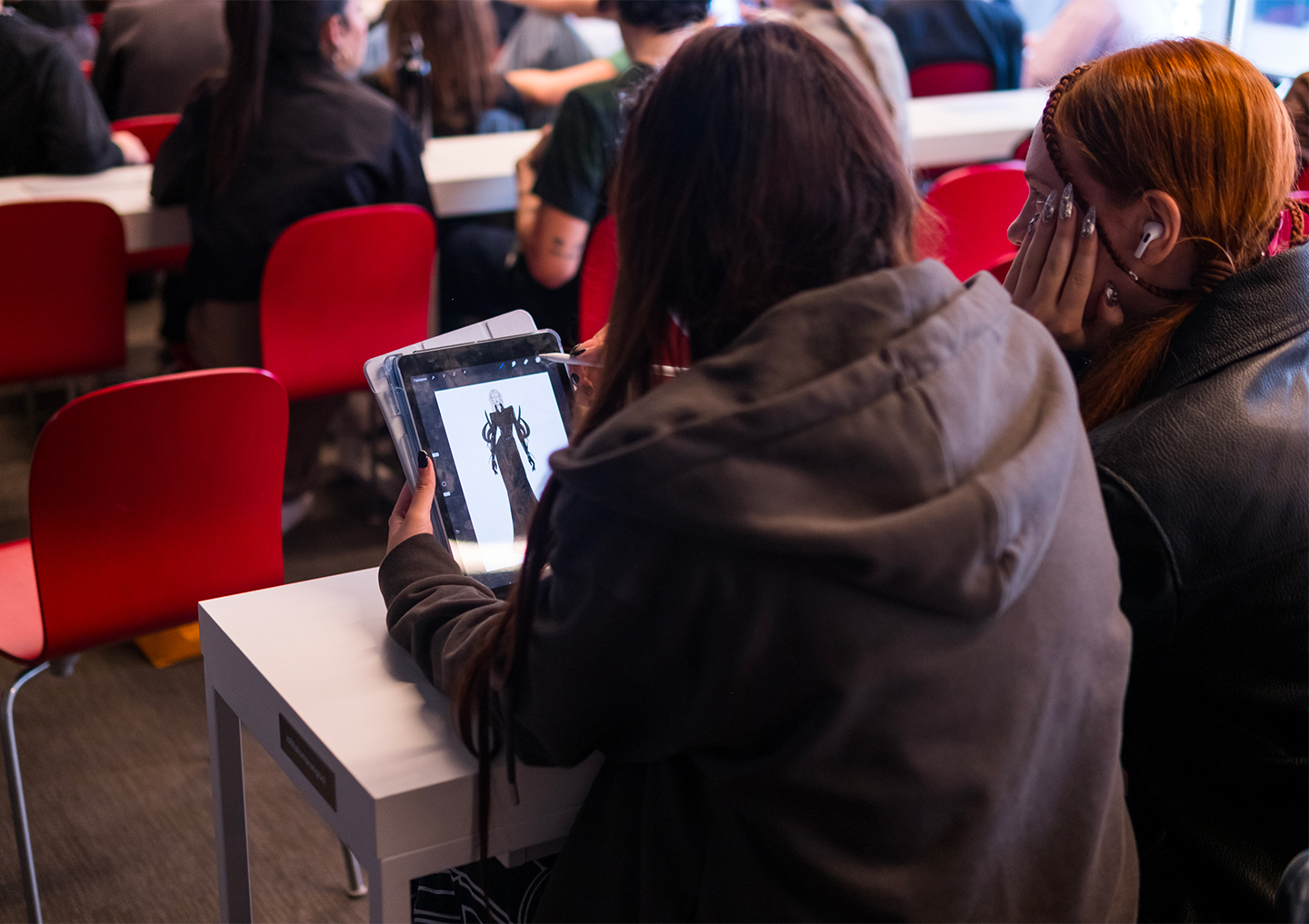 Get creative with Prada and design the perfect accessory. Here are two Istituto Marangoni Milano Fashion Design students starting to sketch during the launch of the contest