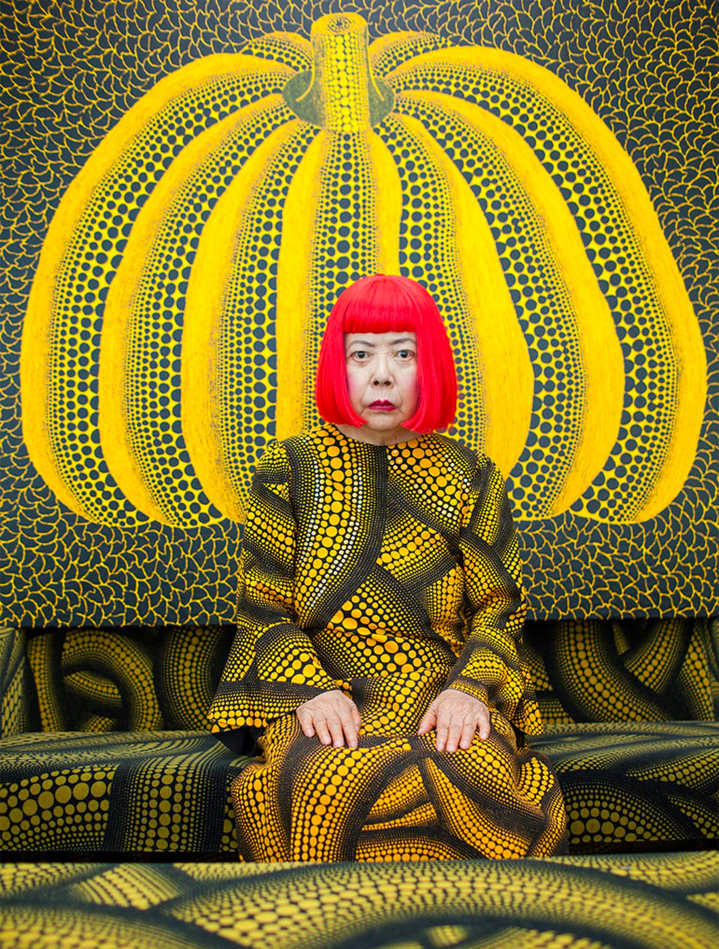 Yayoi Kusama in front of one of her works