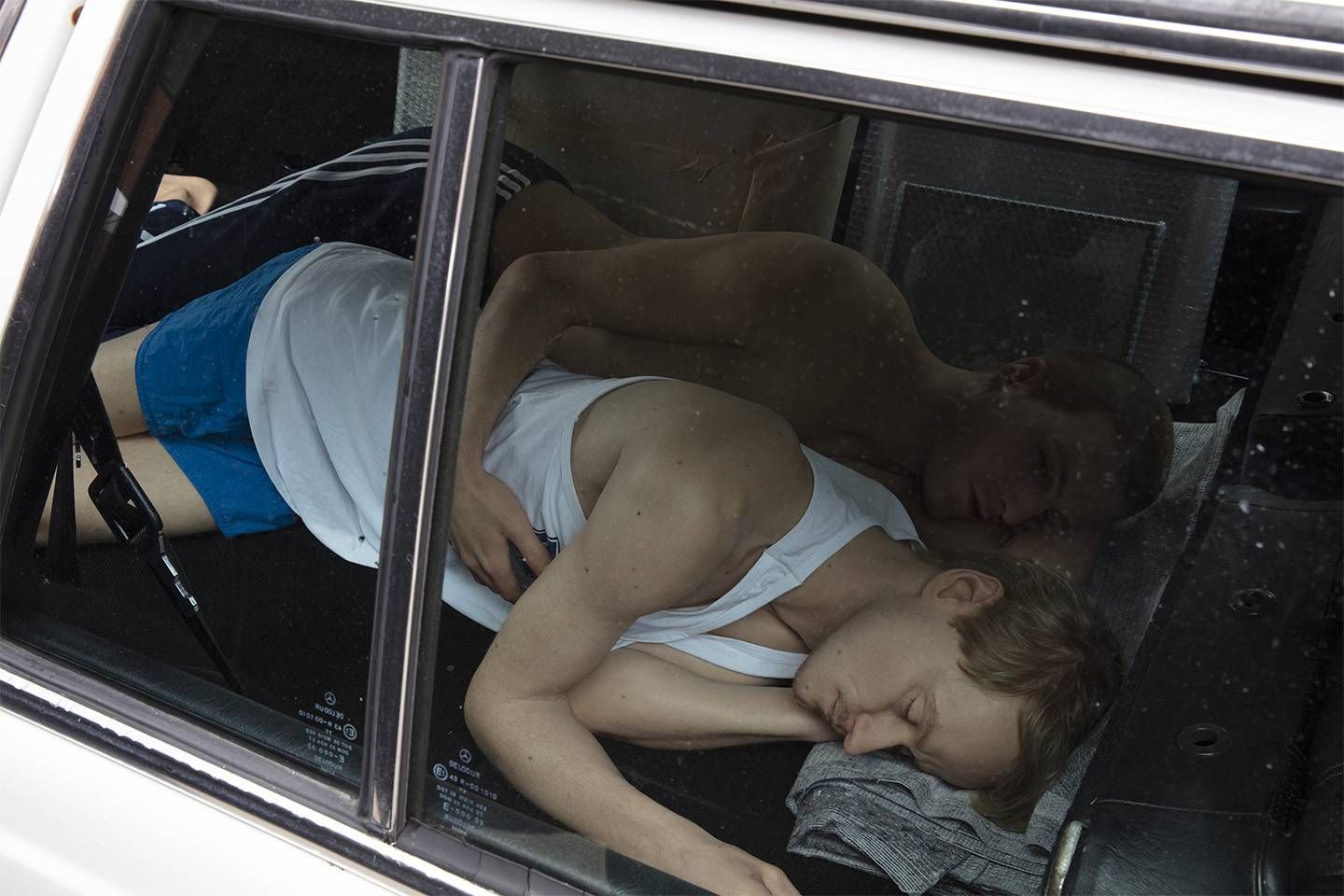 Elmgreen & Dragset The Outsiders (installation view, Unlimited, Art Basel, Basel, 2021) 2020 Mercedes W123, silicone, clothing, packed artworks 140 x 455 x 194 cm Courtesy: Pace Gallery, New York Photo by: Sebastiano Pellion di Persano