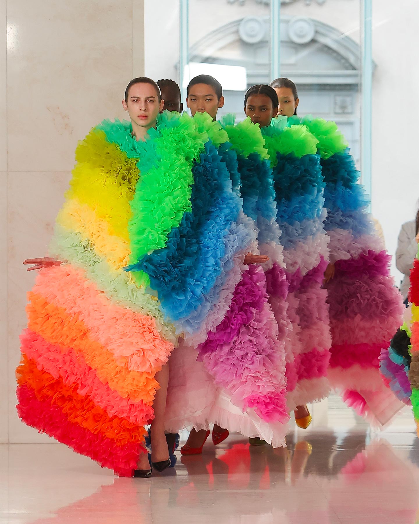 A five-person rainbow dress walked the runway at Tomo Koizumi's show finale as part of his fall 2023 collection, made in collaboration with Dolce&Gabbana and unveiled during the latest Milan Fashion Week