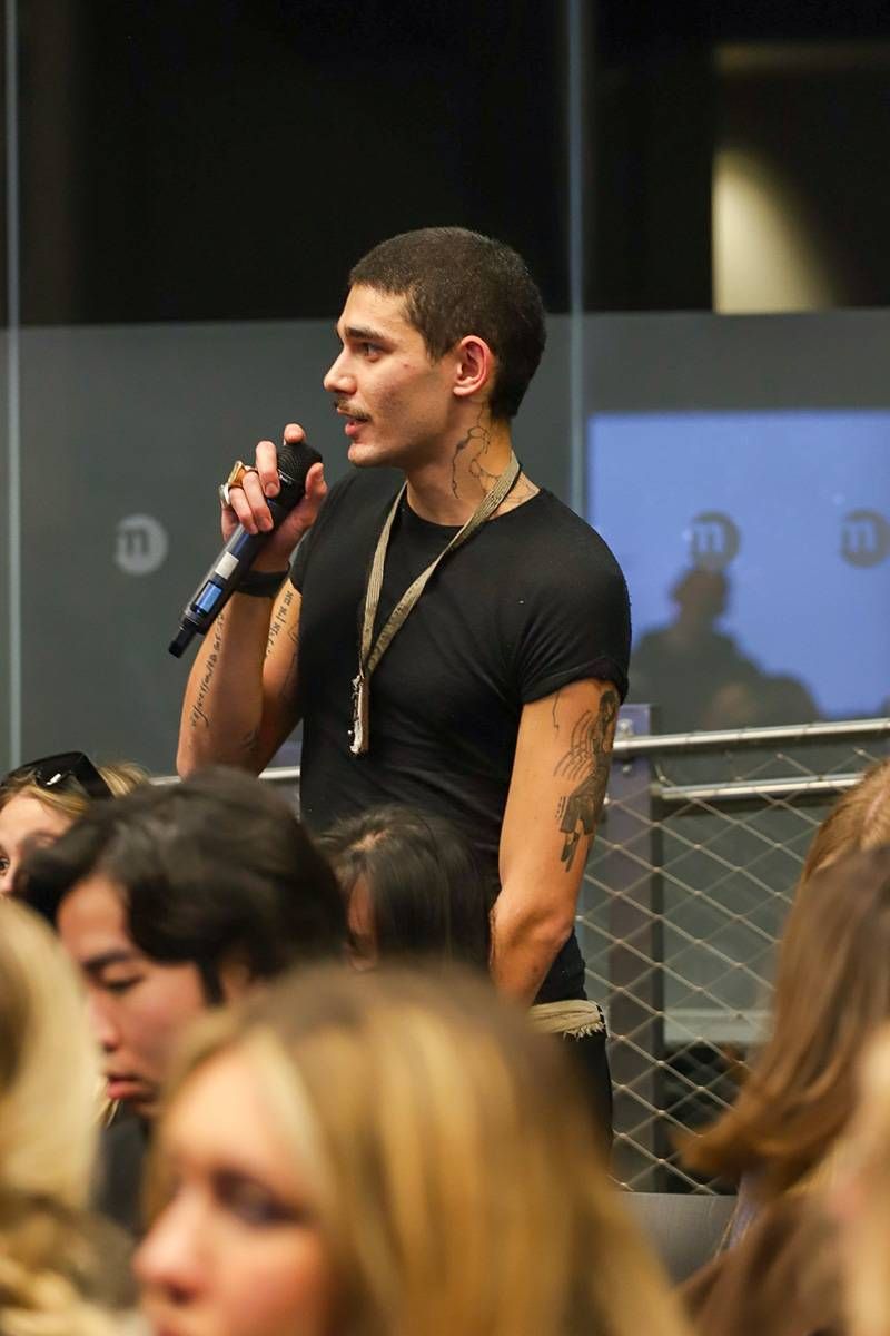 A student engages in discussion during Neil Barrett’s talk, reflecting the dialogue between fashion education, identity and contemporary menswear practice.
